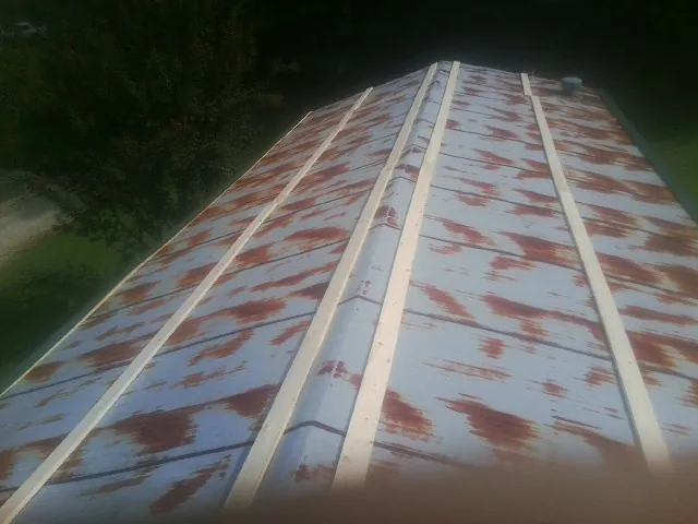 Rusted metal roof panels with new wood purlins before replacement — Storm Damage Roof Repair in Port Gibson by Roofing Brothers